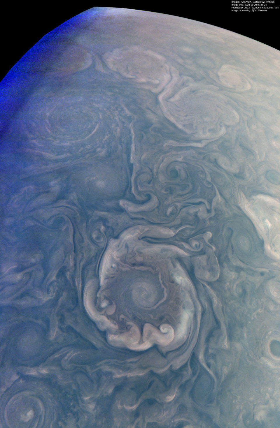 The same frame brightened and stretched until the cyclone is fully legible