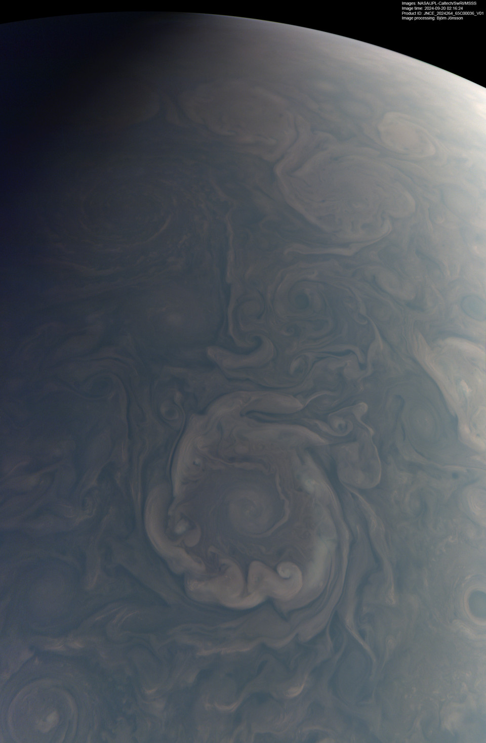 A dark, unbrightened JunoCam frame of a cyclone