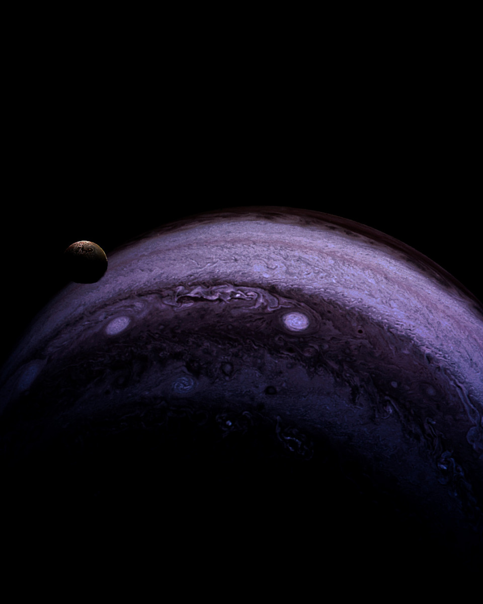 Io as a small mottled disc just clear of Jupiter's shadowed limb