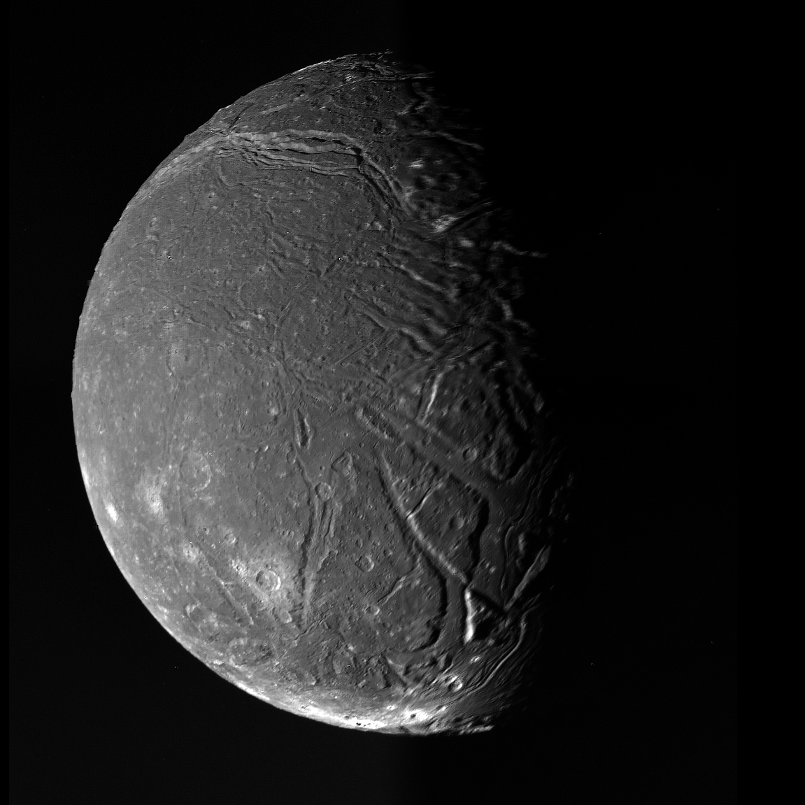 Ariel, a grey globe cut by long branching rift valleys