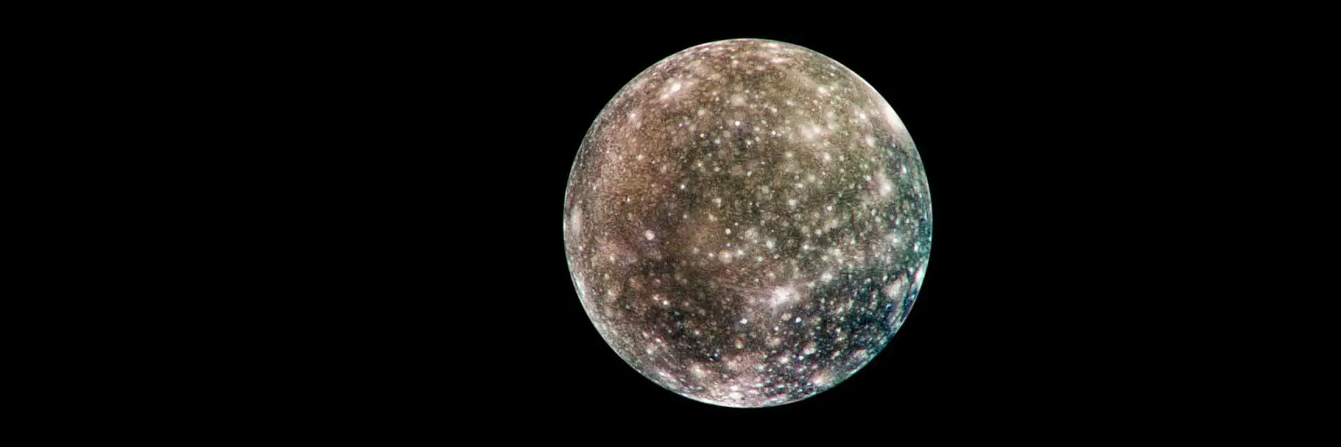 Callisto, densely speckled with bright impact craters across a dark surface