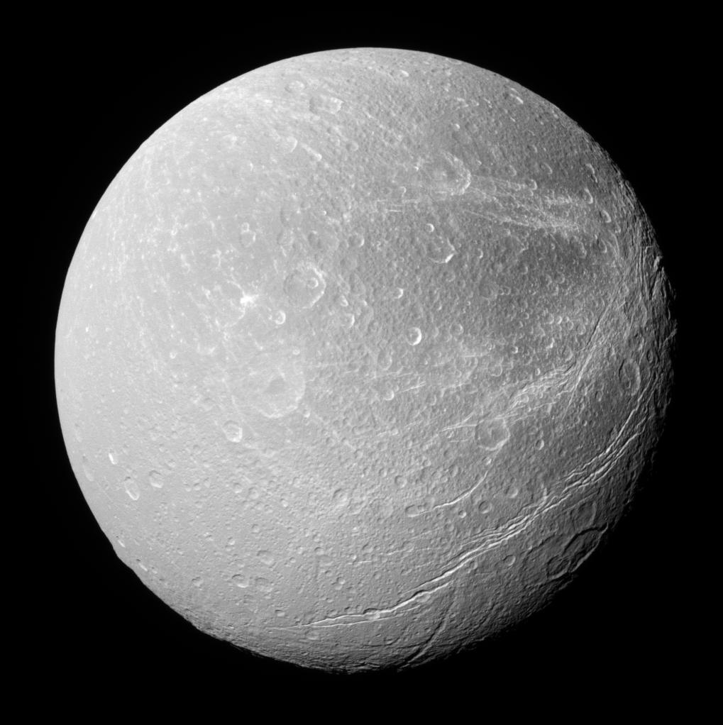 Dione, bright cratered ice streaked with wispy cliffs