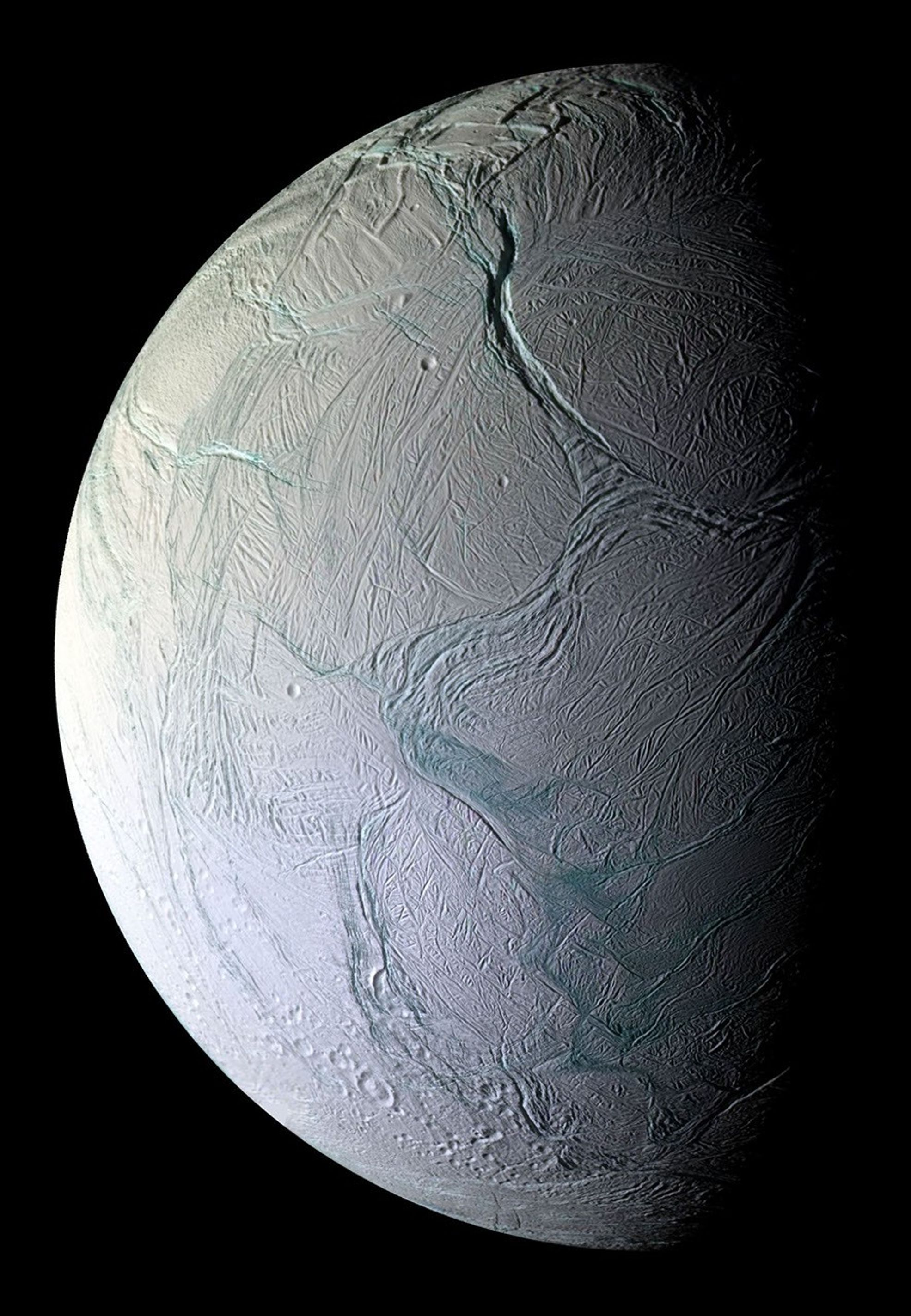 Enceladus, pale blue-white ice cut by long fractures