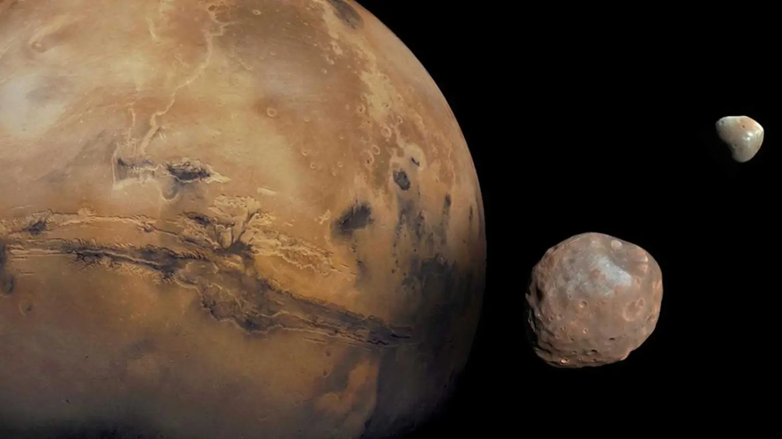Mars with Phobos and Deimos alongside, shown at their relative sizes