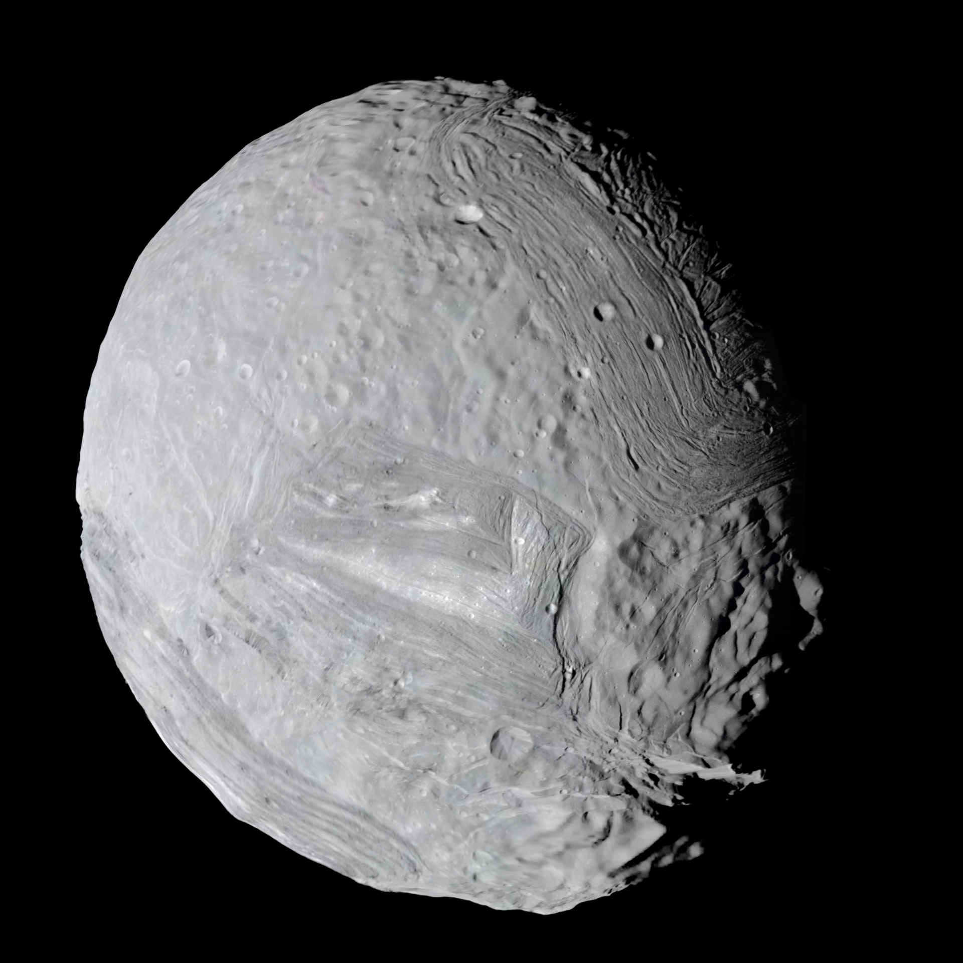 Miranda, a pale battered globe scored by enormous grooved terraces