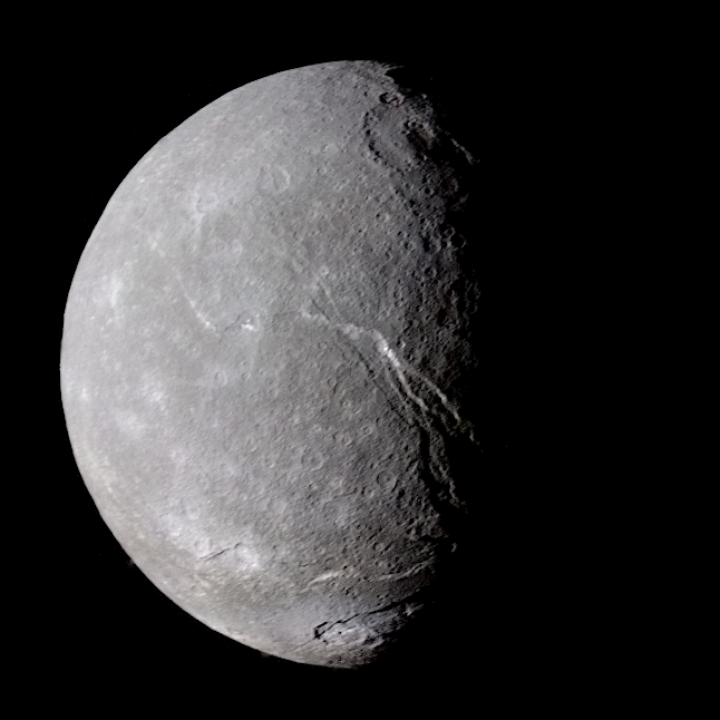 Titania, a grey cratered globe with a long scarp running down its terminator