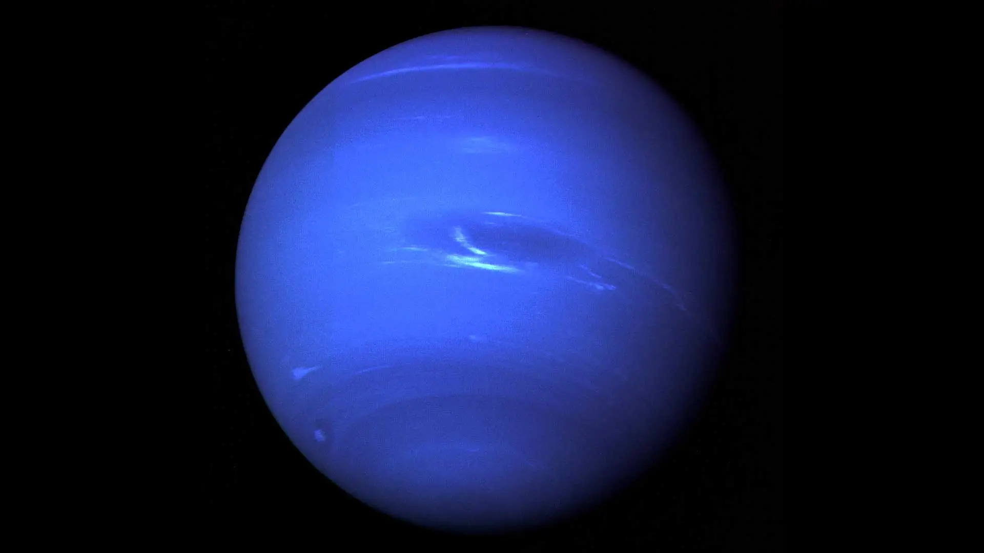 Neptune as a deep blue disc with the Great Dark Spot near the centre