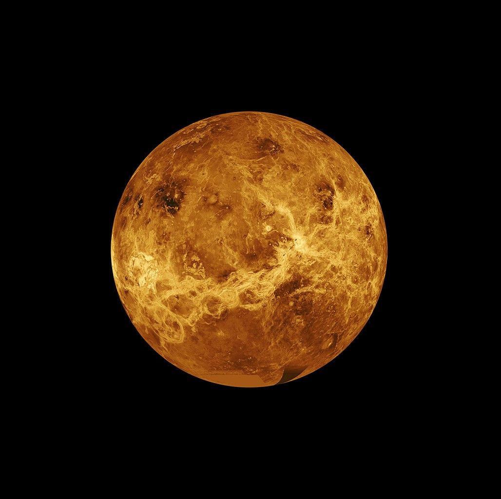 Venus as a full ochre disc, its surface picked out in radar